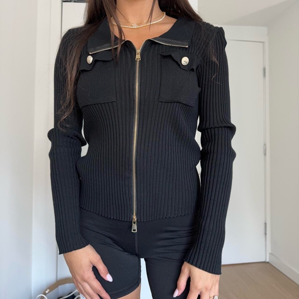 Black zip up cardigan sweater with gold buttons and zipper